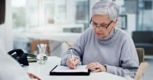 a woman filling out a building certificate of insurance