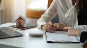 a woman signing contractors general liability insurance